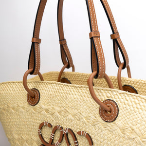 LOEWE MEDIUM ANAGRAM BASKET TOTE BAG IN IRACA PALM AND CALFSKIN NATURAL / TAN