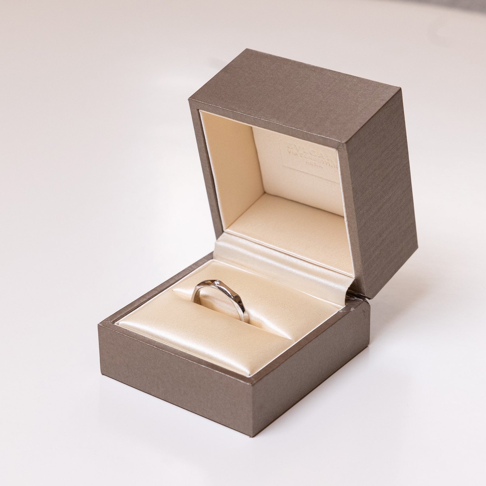 BVLGARI INFINITO WEDDING BAND IN PLATINUM SET WITH ONE DIAMOND