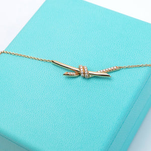 TIFFANY KNOT PENDANT IN YELLOW GOLD WITH DIAMONDS